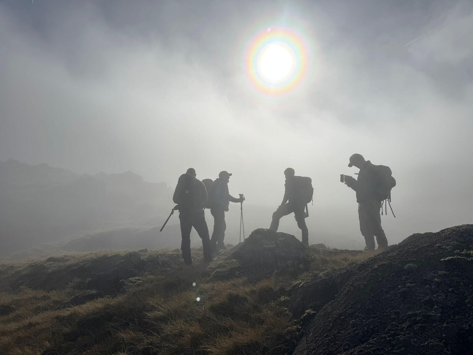 Image of people map reading on a foggy mountain